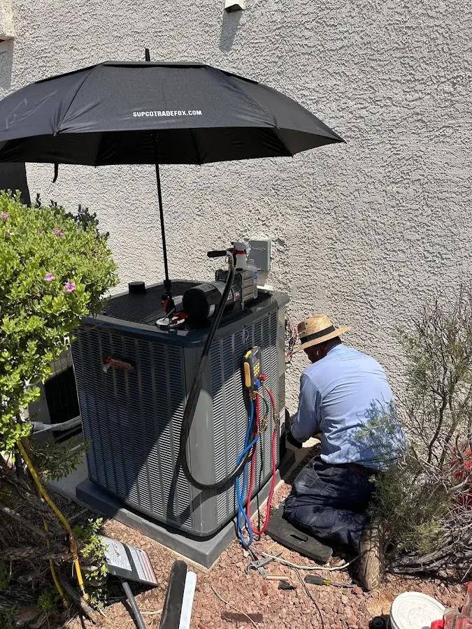 HVAC technician performing outdoor AC maintenance in Hazel Dell