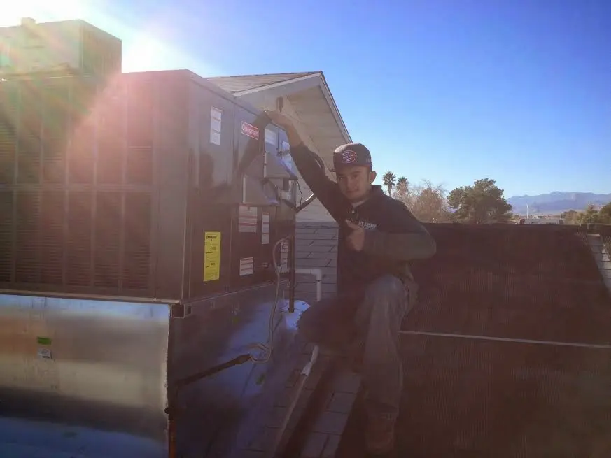 HVAC technician performing HVAC Inspection on a rooftop unit in Hazel Dell